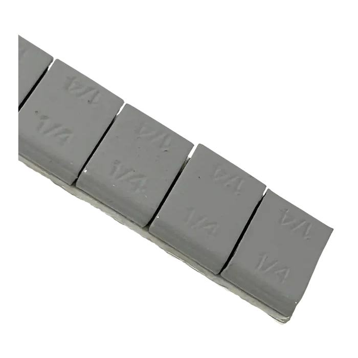 Gray 1/4 oz adhesive wheel weight keychain with embossed markings