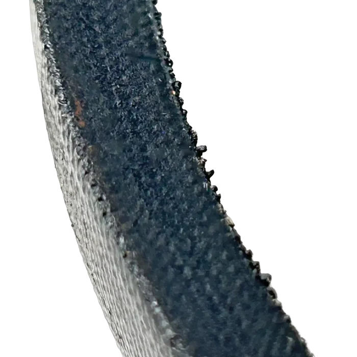 Curved section of a dark, textured belt or strap with a rough edge.