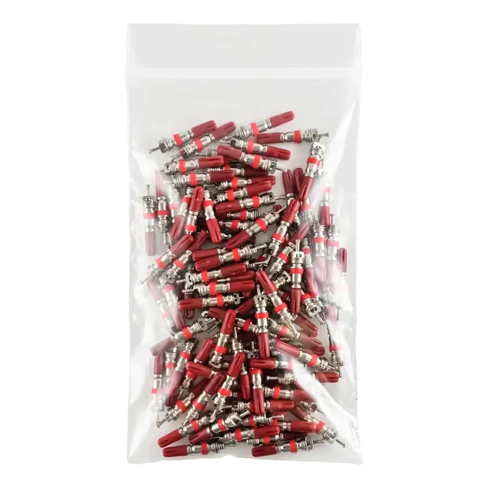 Plastic bag filled with red and silver electrical connectors or terminals.