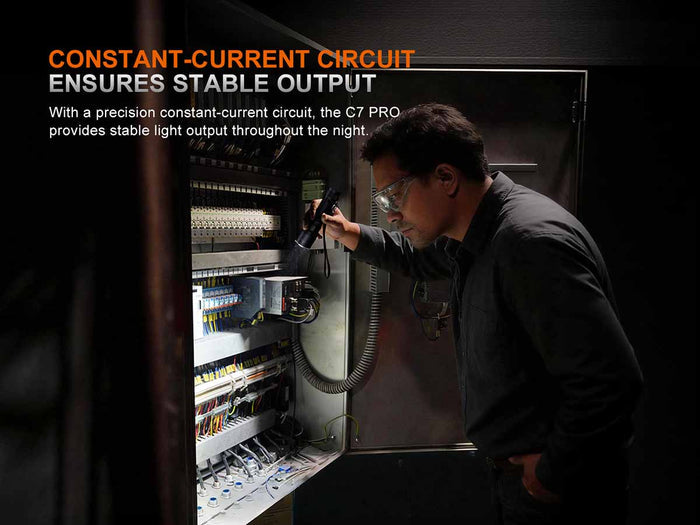 Person working on electrical equipment using the Fenix C7 Pro with text about a constant-current circuit and stable output
