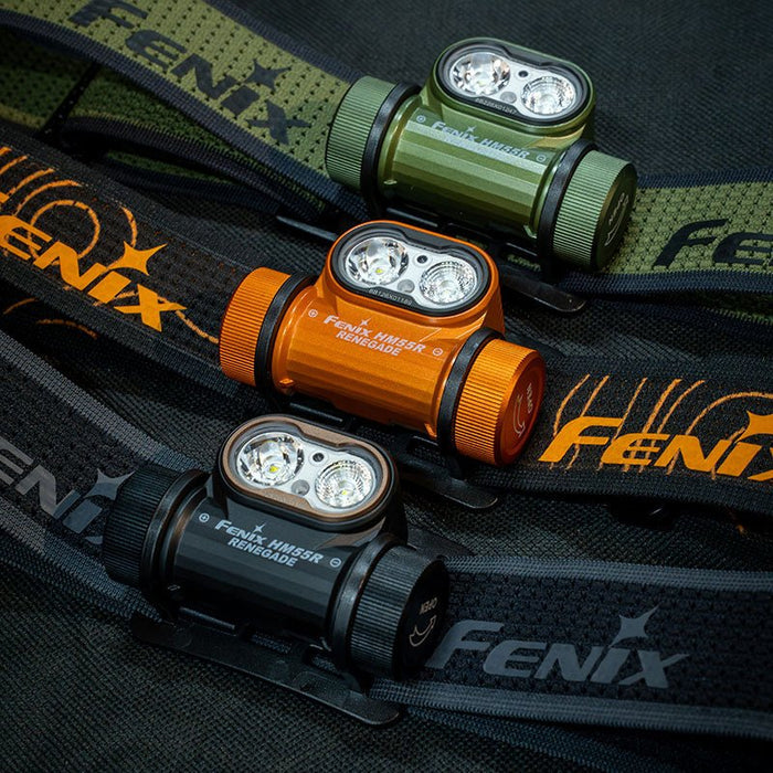 Three Fenix HM55R RENEGADE headlamp color options (green, orange, and black) on black background