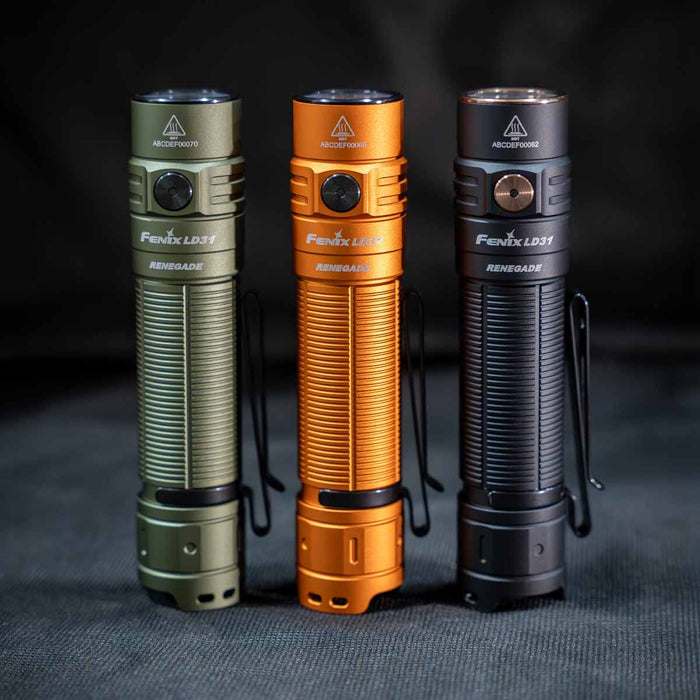 Three Fenix LD31 RENEGADE Flashlights in green, orange, and black to show color options on a dark background.